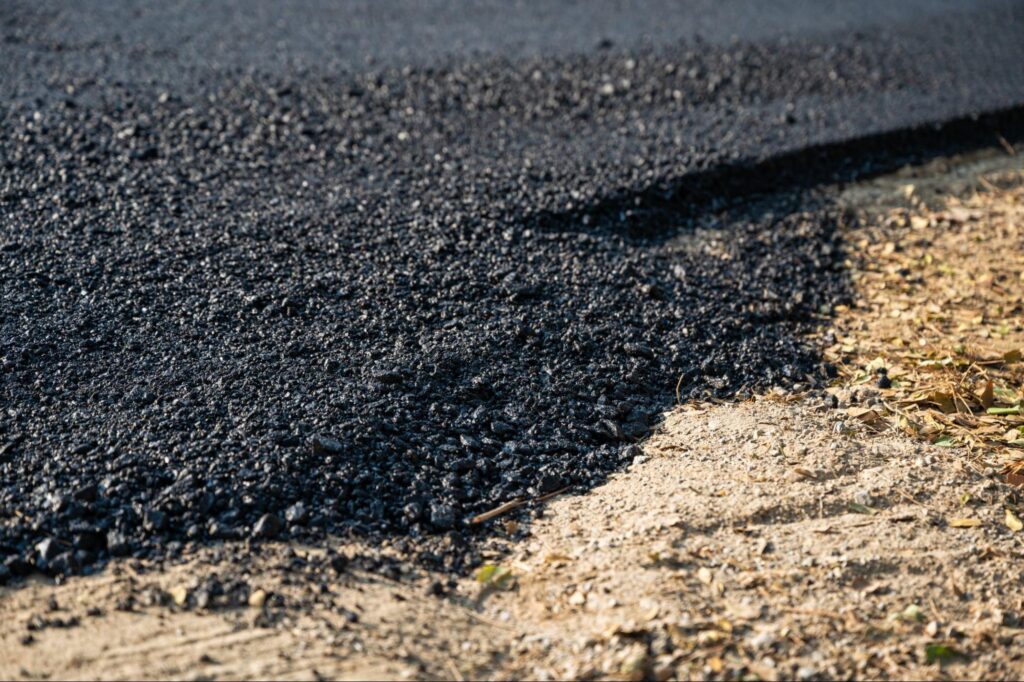 New asphalt being paved. 