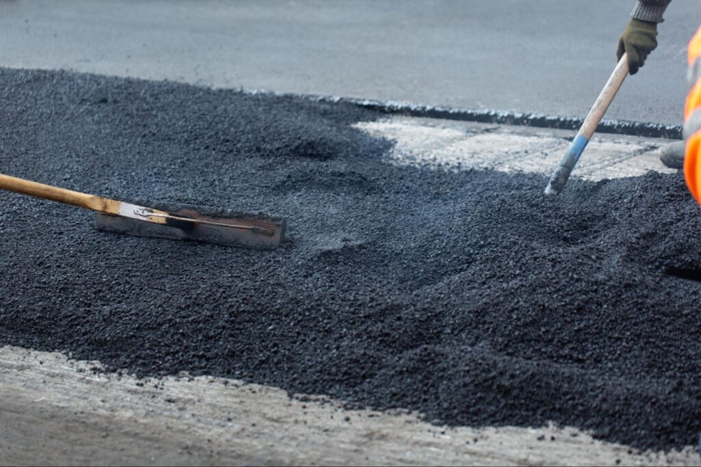 Construction workers working with asphalt.